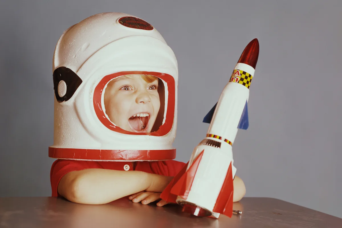 Happy Boy in Astronaut Costume with Spaceship