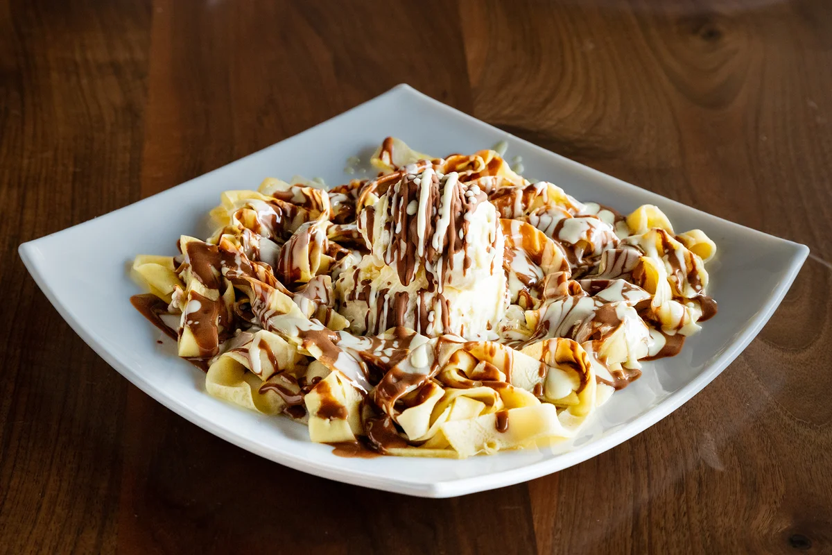 Innovatice recipe of strips of sweet crepe topped off with a scoop of vanilla ice cream