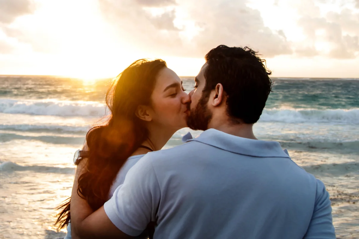 Happy couple kissing on beach