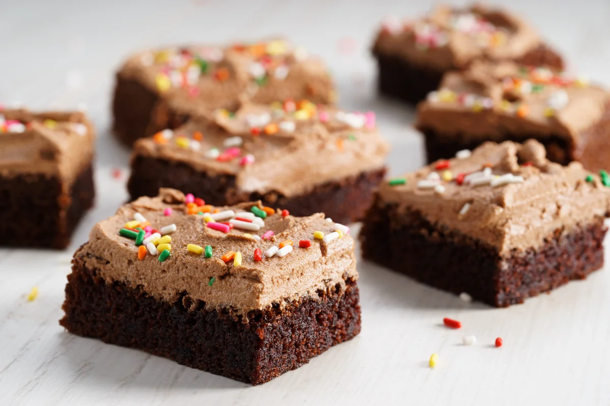 Iced brownies with sprinkles on top.