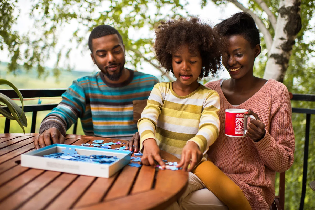 Family playing with puzzles on a terrace