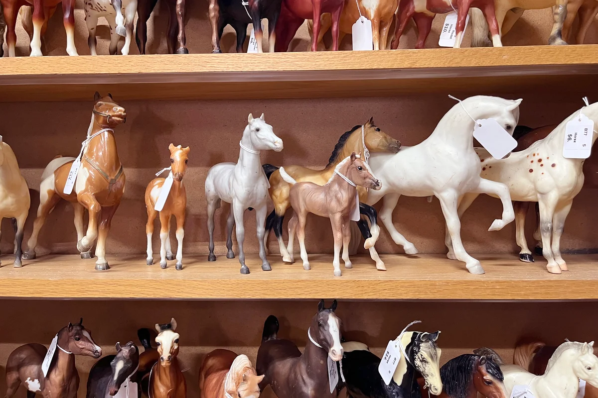 A collection of antique toy horse figures