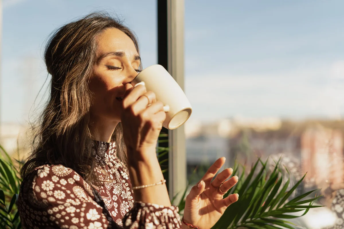 woman drinking coffee in the morning at home