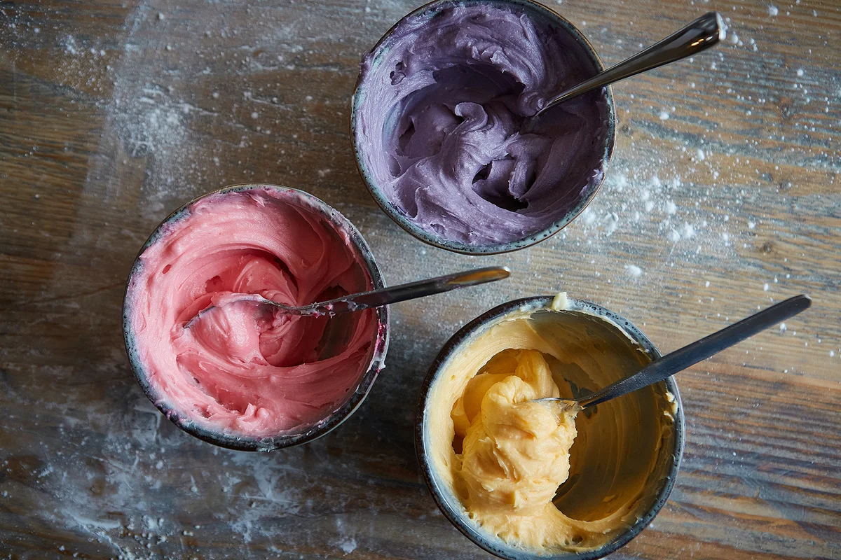 Close up top down shot of coloured buttercream icing mixture