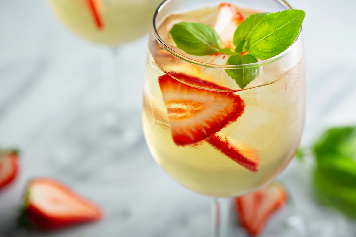 White wine cocktail with strawberries and basil