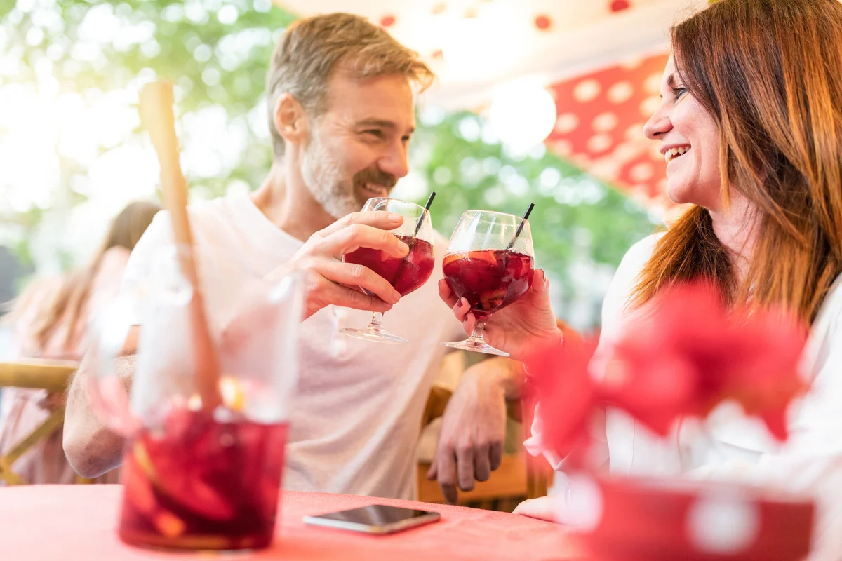 Couple having red wine cocktails at a bar