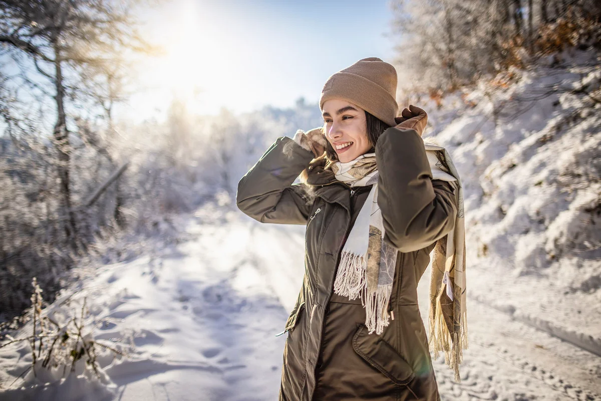 woman enjoys snowy winter day