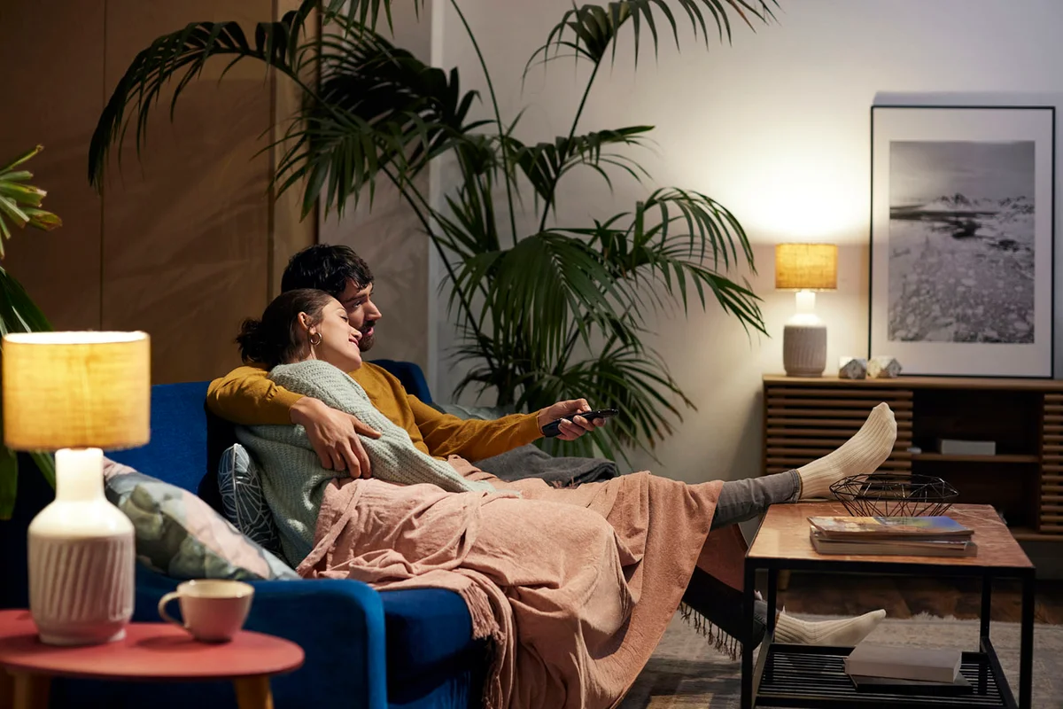 Relaxed couple sitting on sofa in living room