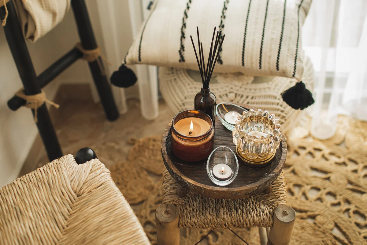 Home decoration with burning candles on wooden coffee table