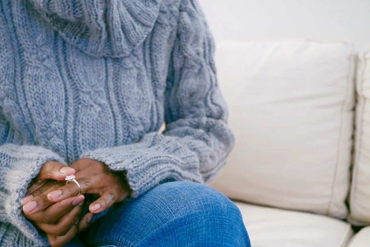woman removing engagement ring