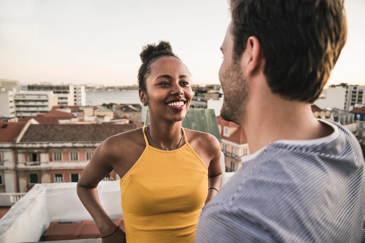 two people talking on a roof