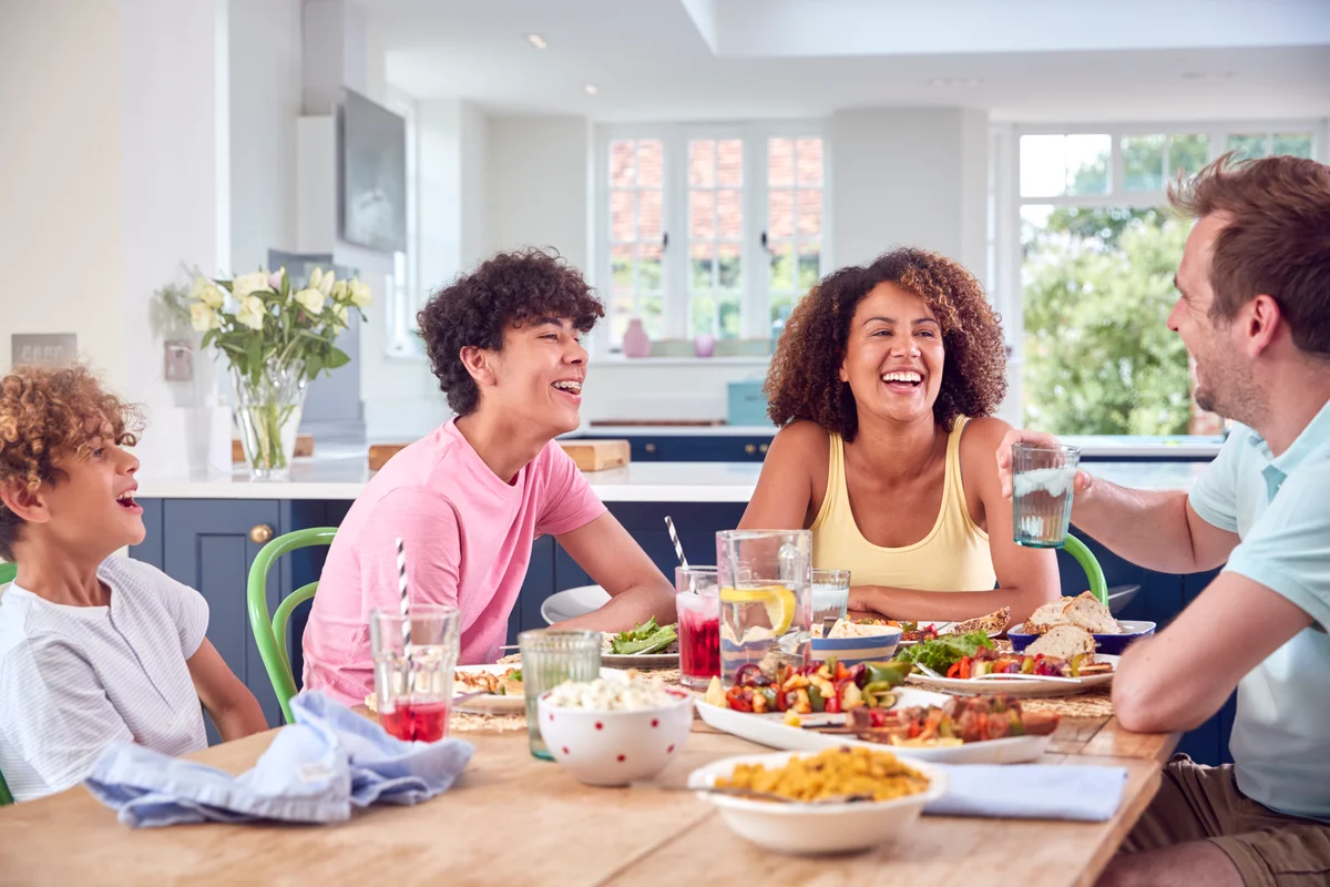 middle school kids laughing at dinner table