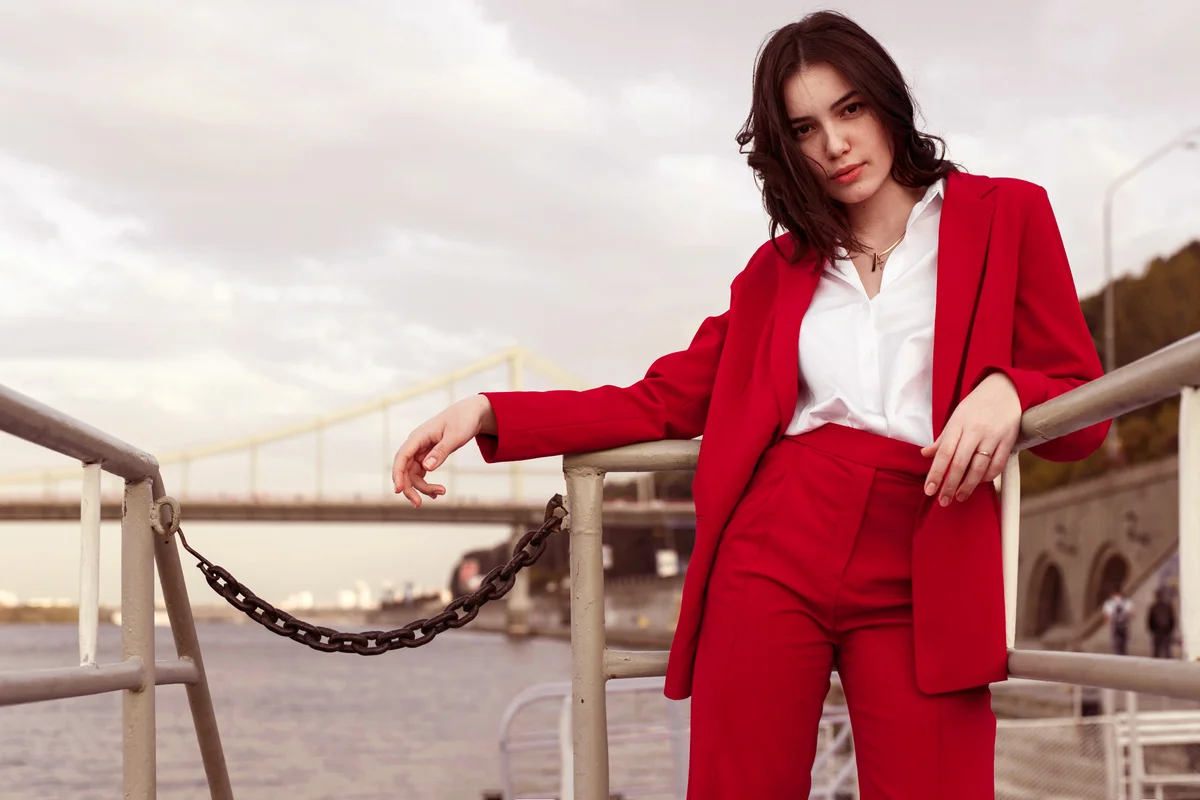 Woman in red pantsuit walking in the city