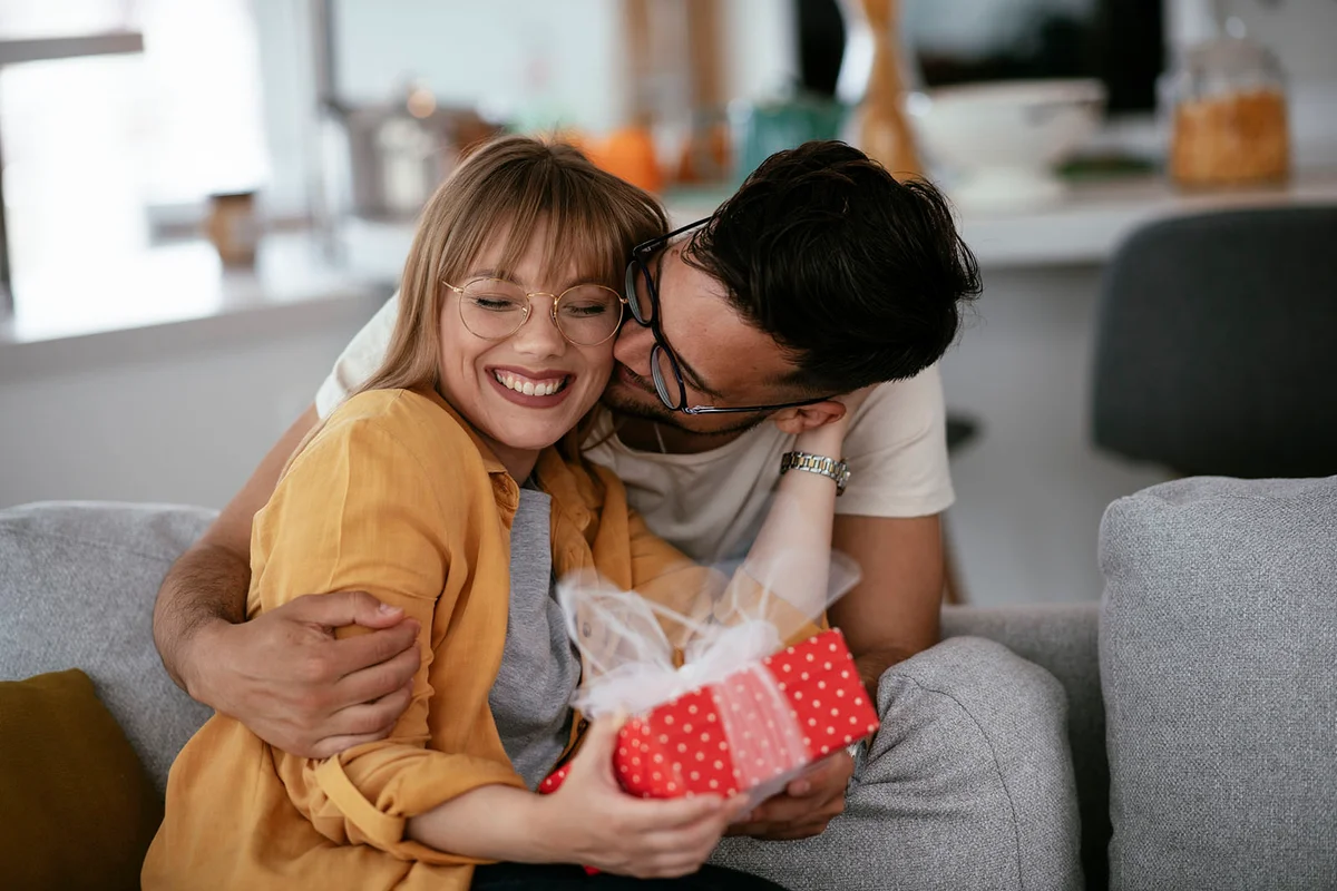 Husband surprising his wife with a gift