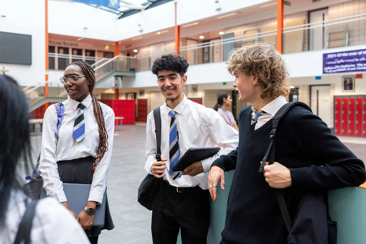 group of teenage students who are waiting to go into class in the high school