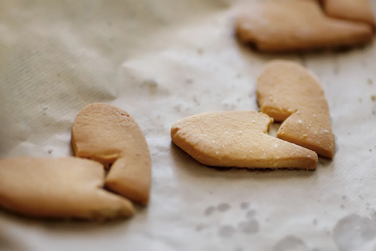Delicious fresh biscuits made of crumbly dough in shape of heart halves