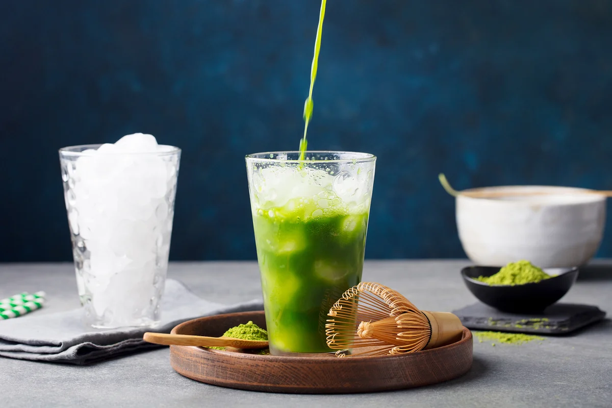 Matcha Green Tea Ice Tea Pouring In Tall Glass