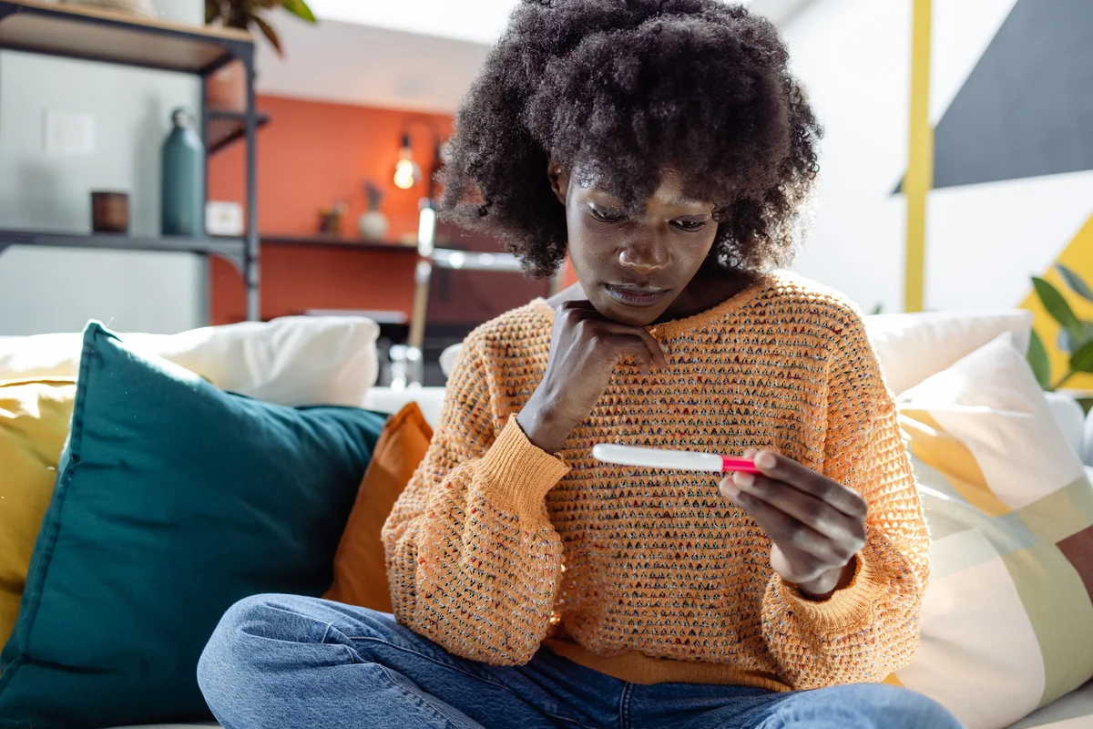 woman looking at a pregnancy test