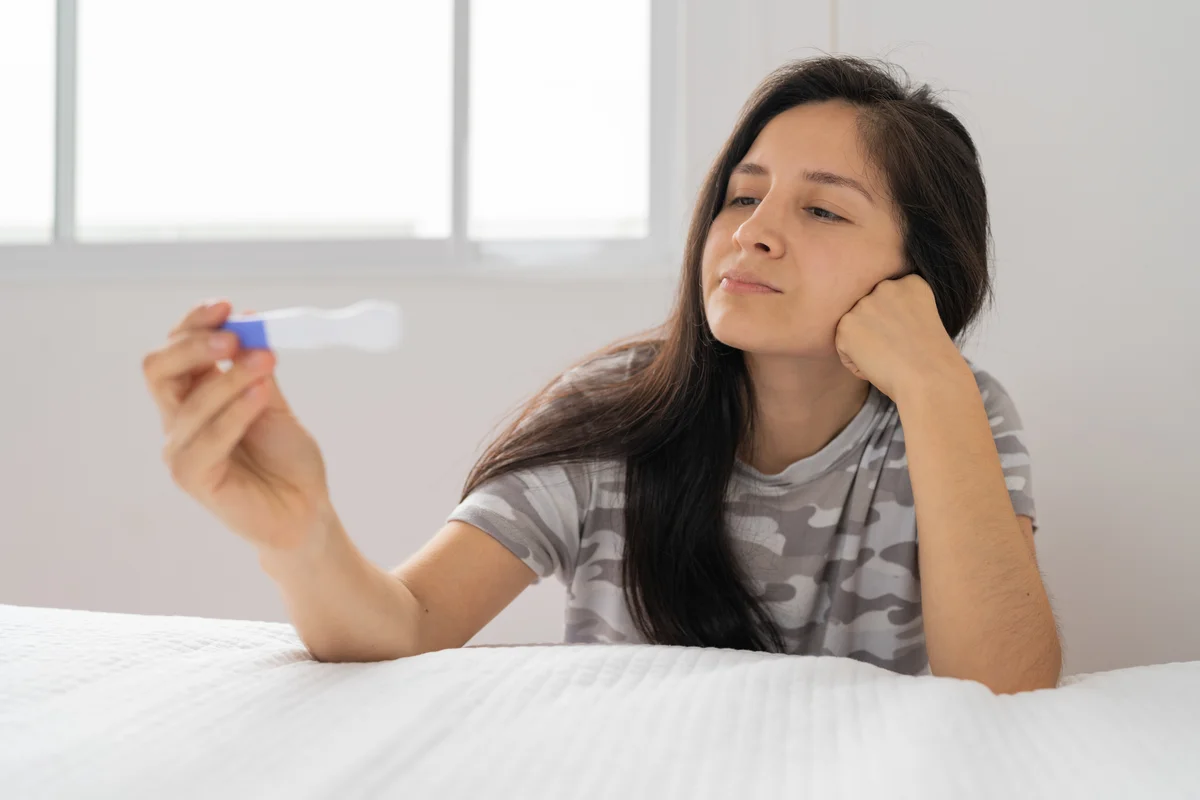 woman looking at pregnancy test