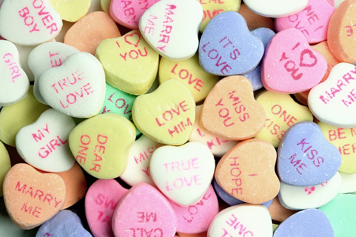 Frame filled with tons of pastel colored candy conversation hearts