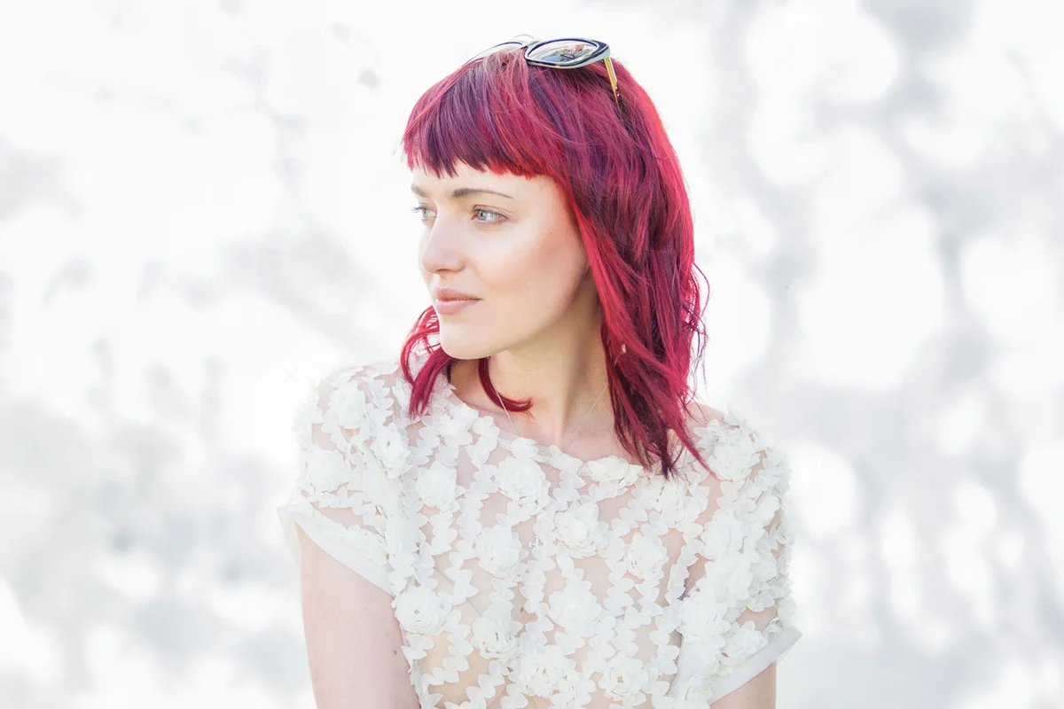 Portrait of feminine young woman with pink hair