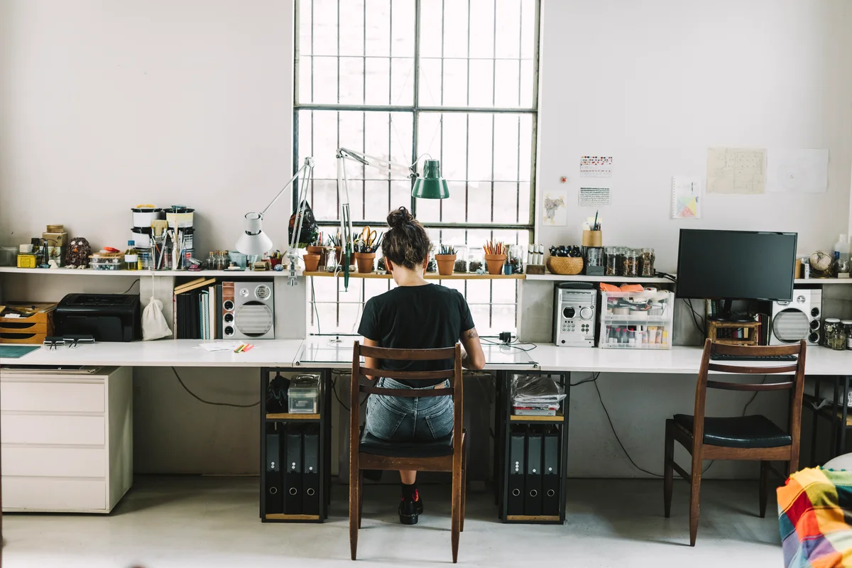 Rear view of artist freelancing at home