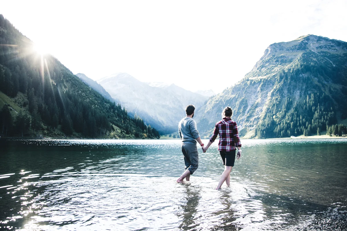 couple wading in an Austrian lake