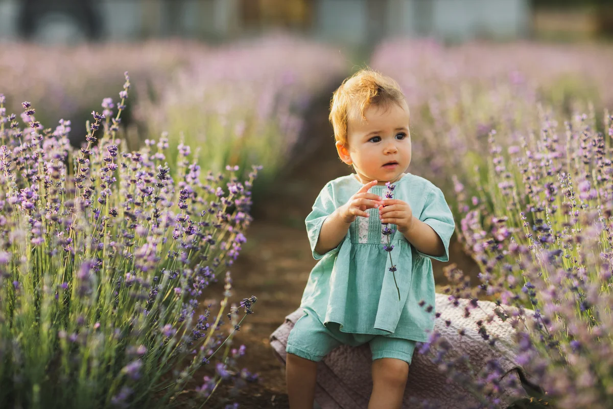Happy toddler baby girl in dress in lavender field