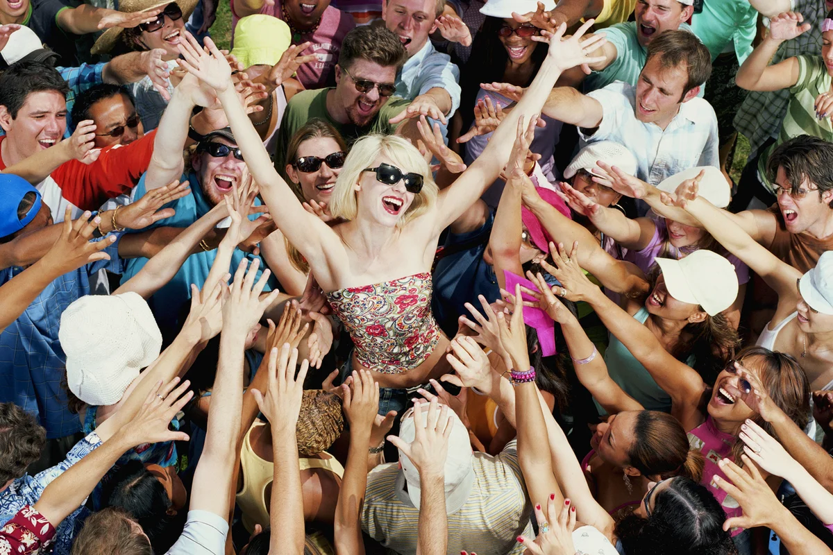 Young adults reaching for female celebrity
