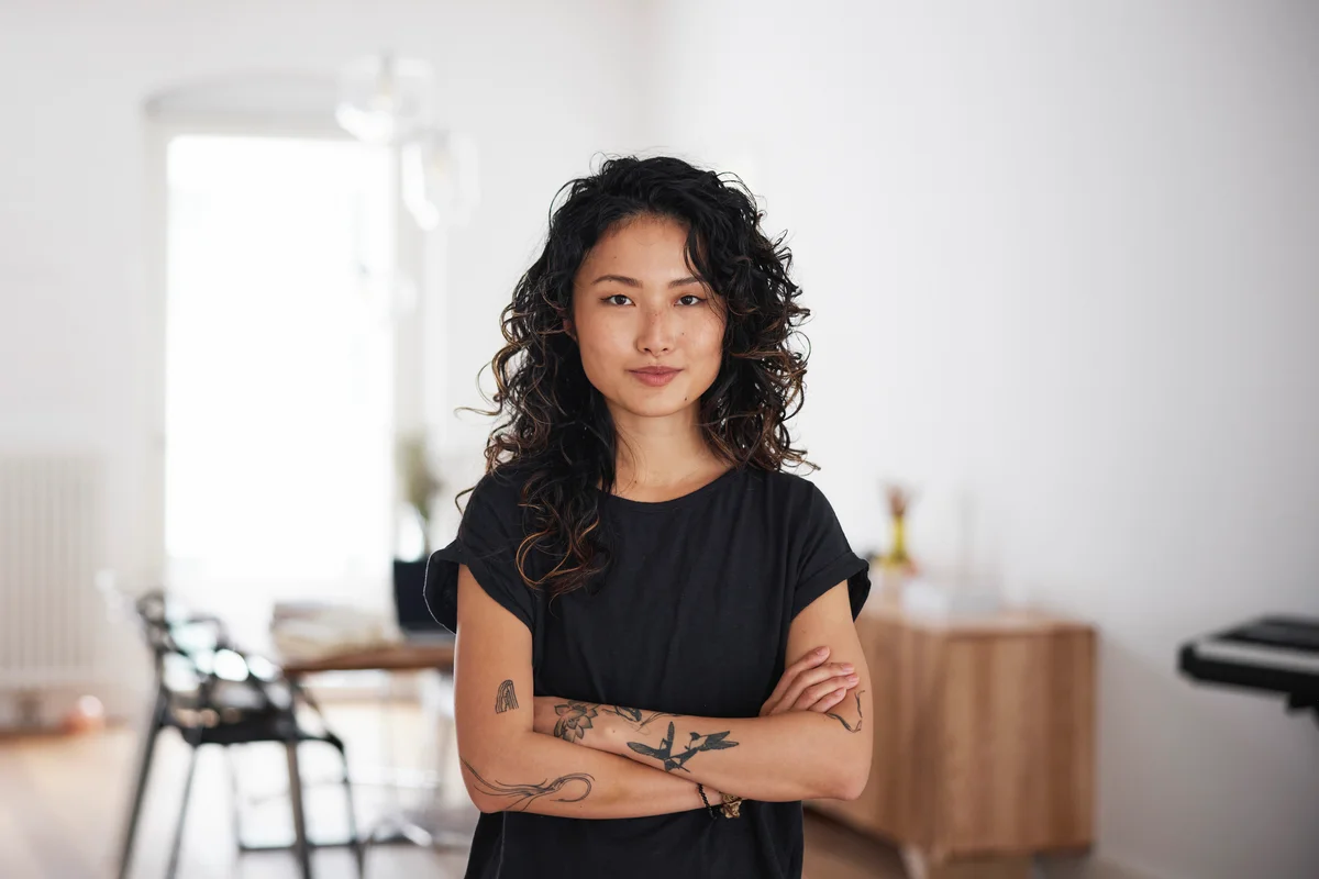 young asian woman standing in living room