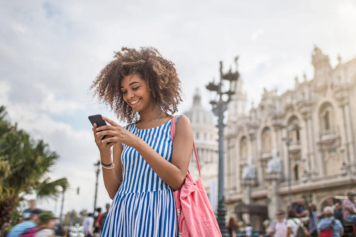Woman texting on smart phone in city