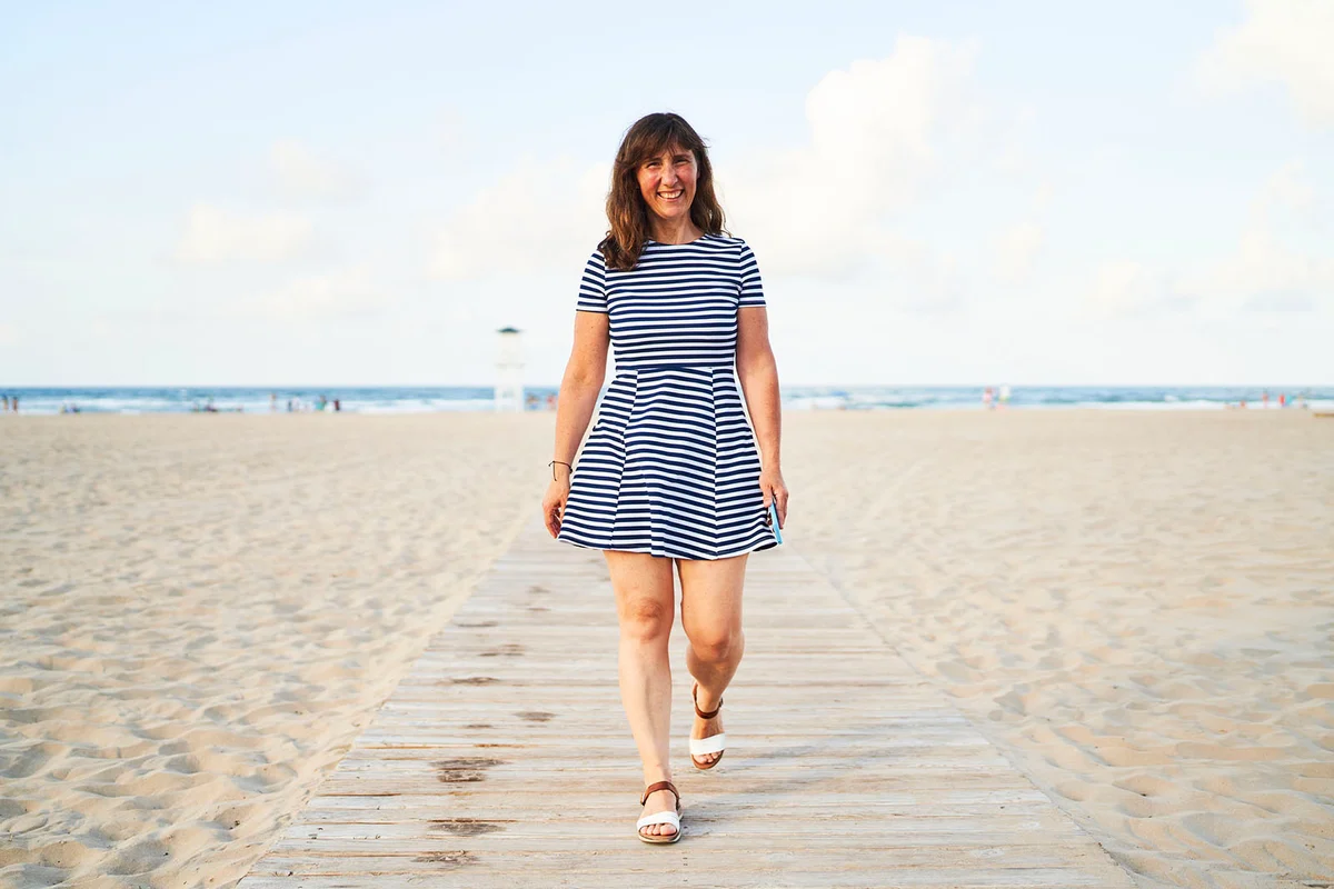 woman in casual clothes walking on the beach