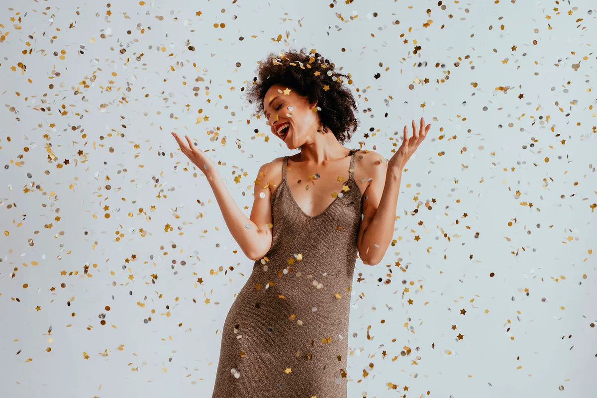 Woman Dancing in Confetti Rain