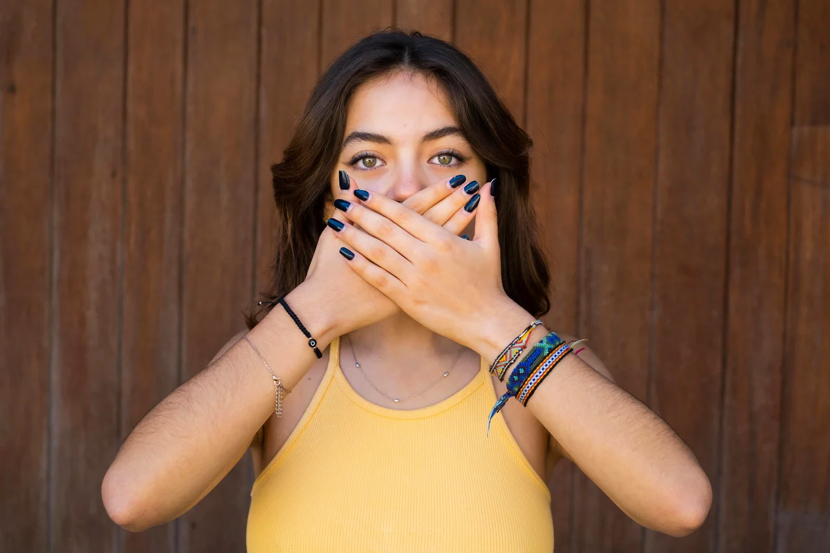 woman covering her mouth