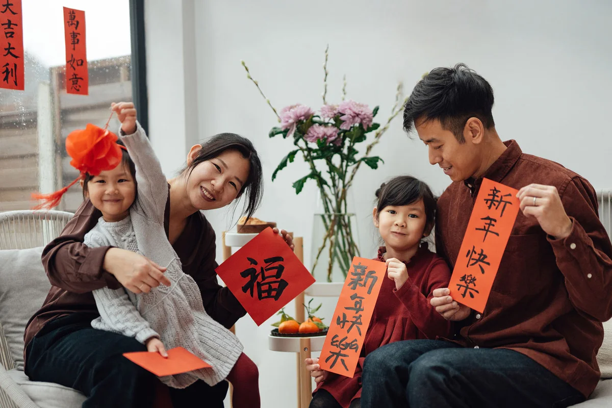 Cheerful Two-generation Asian Family Portrait for Chinese New Year