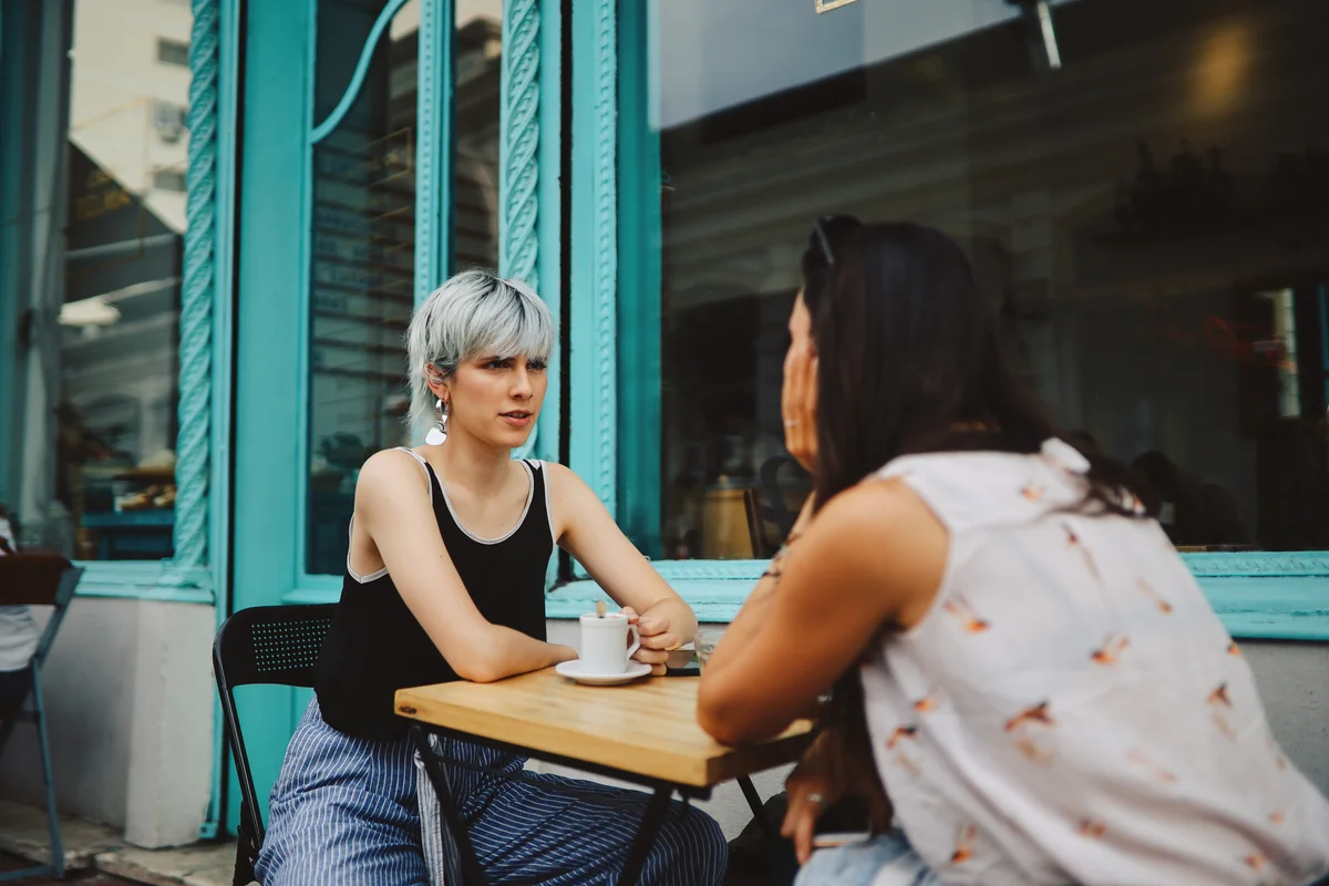 women sitting and talking in the street café