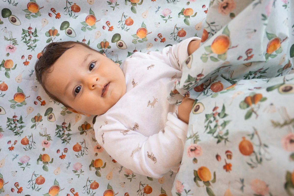 Overview of a baby playing on a colorful background