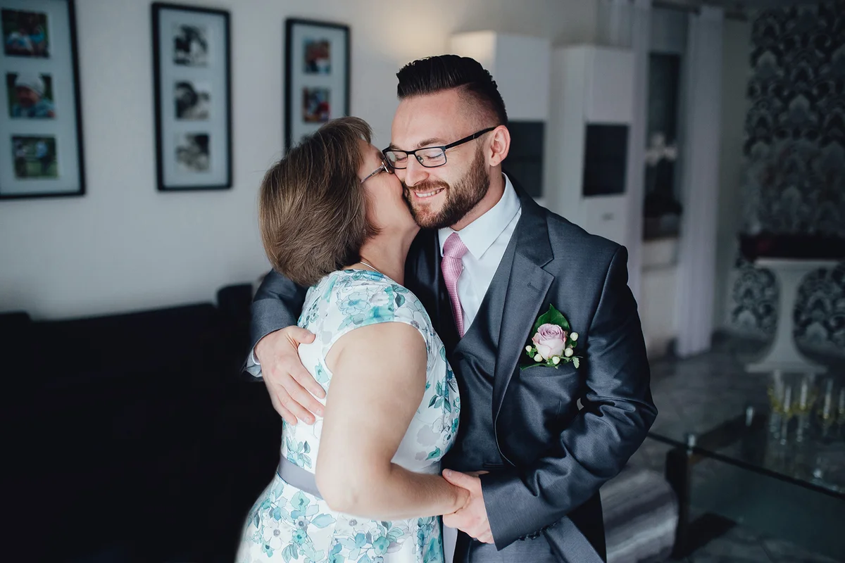 handsome groom with his mother