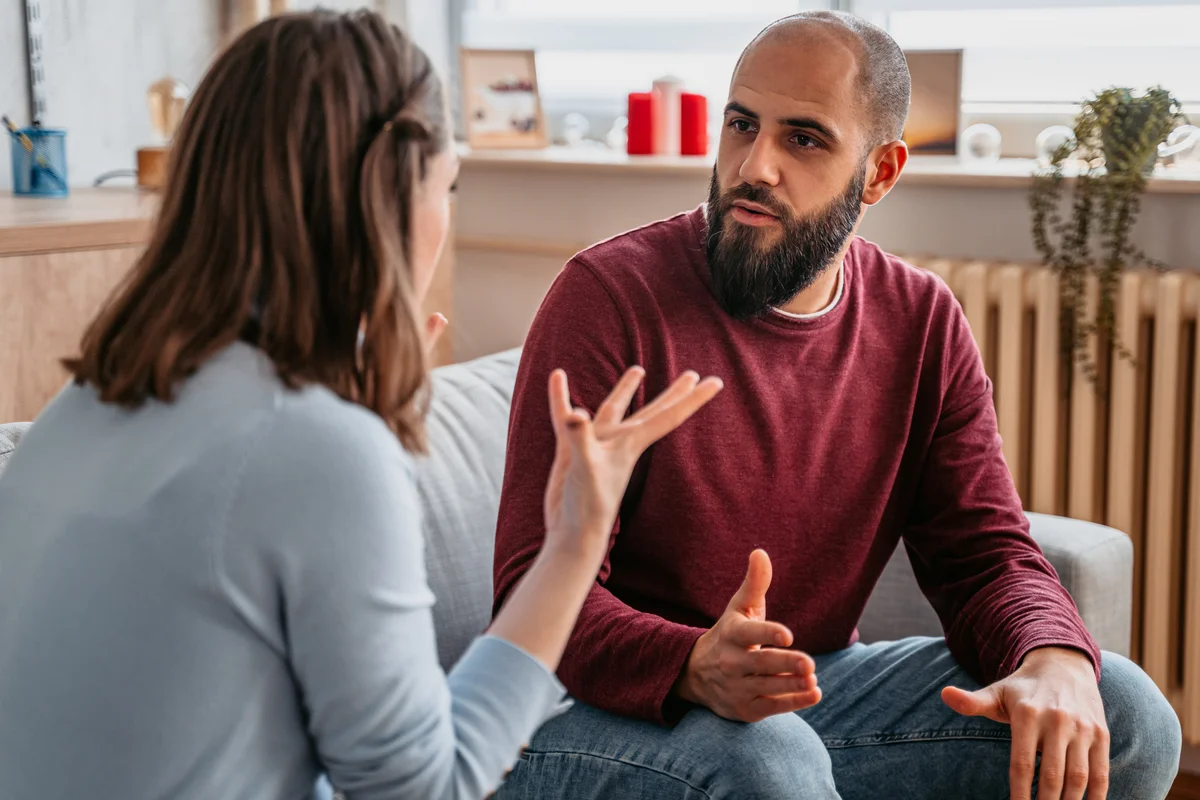 Young couple with relationship problems arguing at home