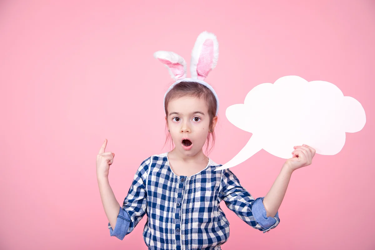 Little girl in bunny ears with a speech bubble