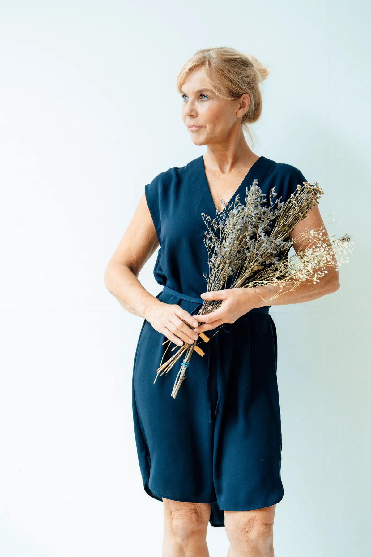 Older woman holding flowers