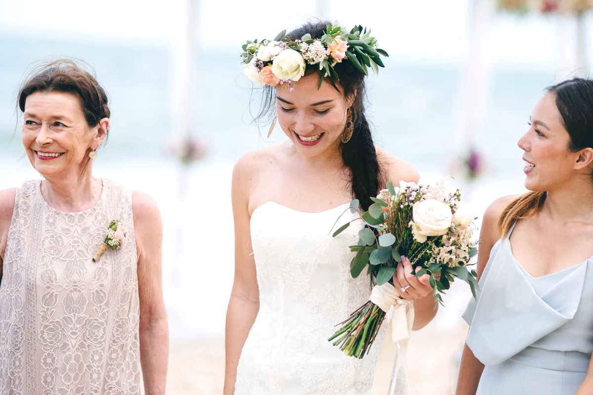 Bride and wedding guests at beach