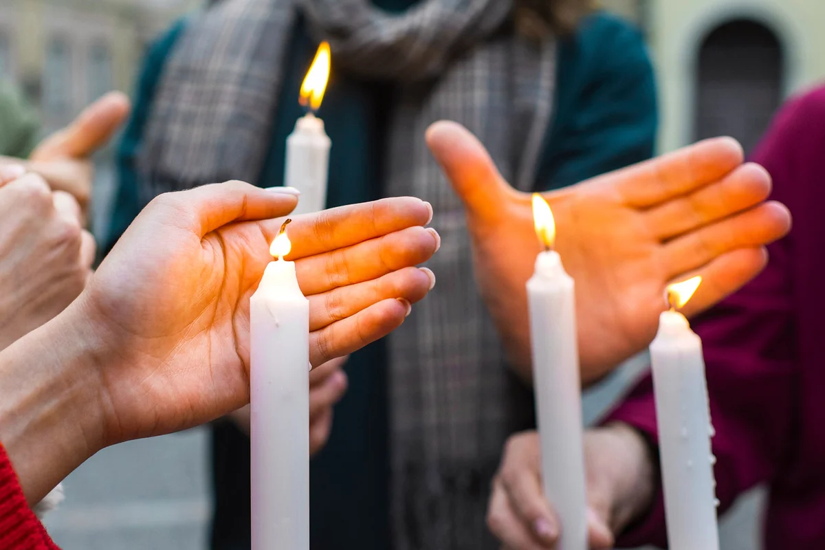 People holding candles during vigil