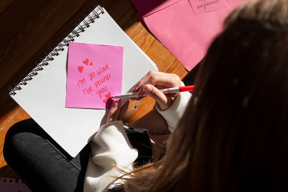 Woman writing a romantic love letter to someone