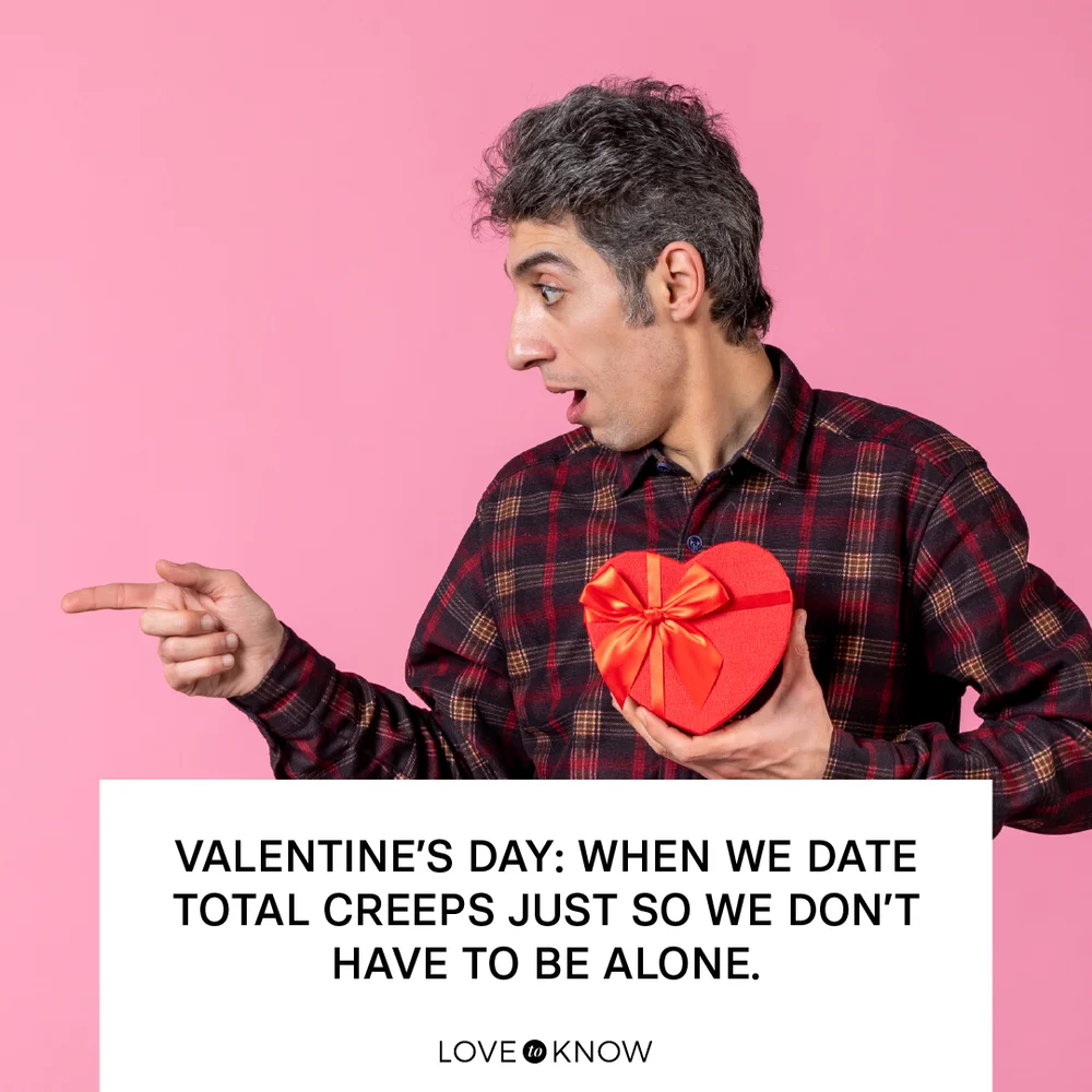Man holding red heart shaped present