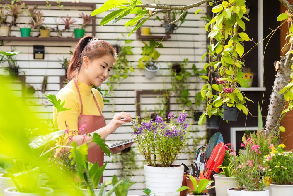 Woman holding a laptop in garden