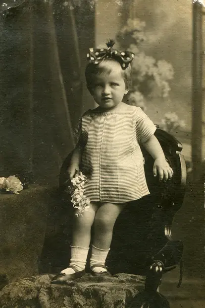 Little girl in a striped dress with a bow on her head, 1920s