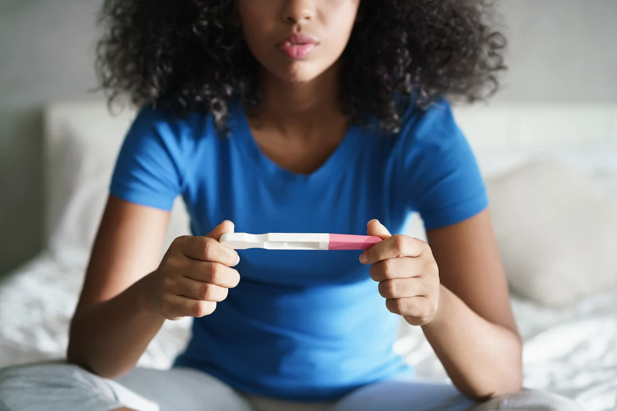 Disappointed teen getting unexpected result from pregnancy test kit