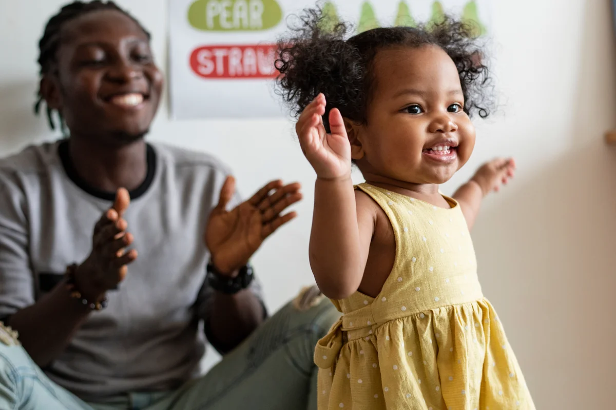 Father and toddler dancing