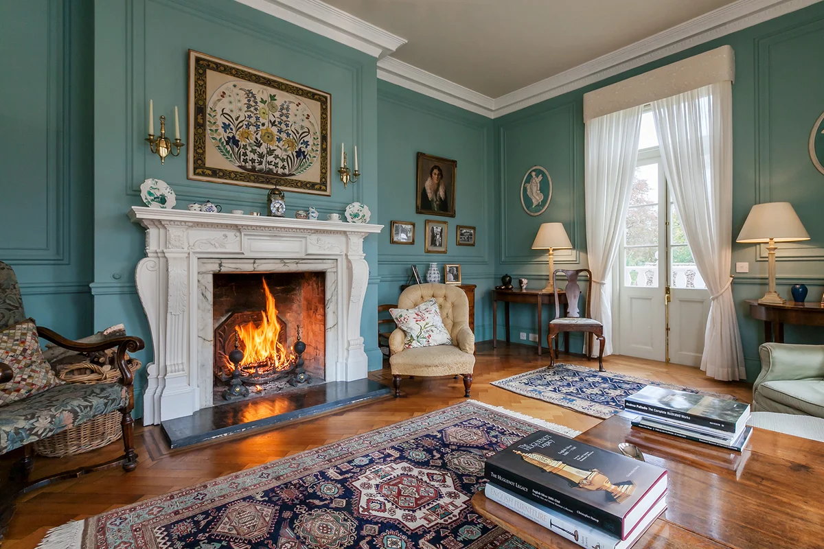 Drawing and living room within grand historic property with many original traditional featurea and roaring fire